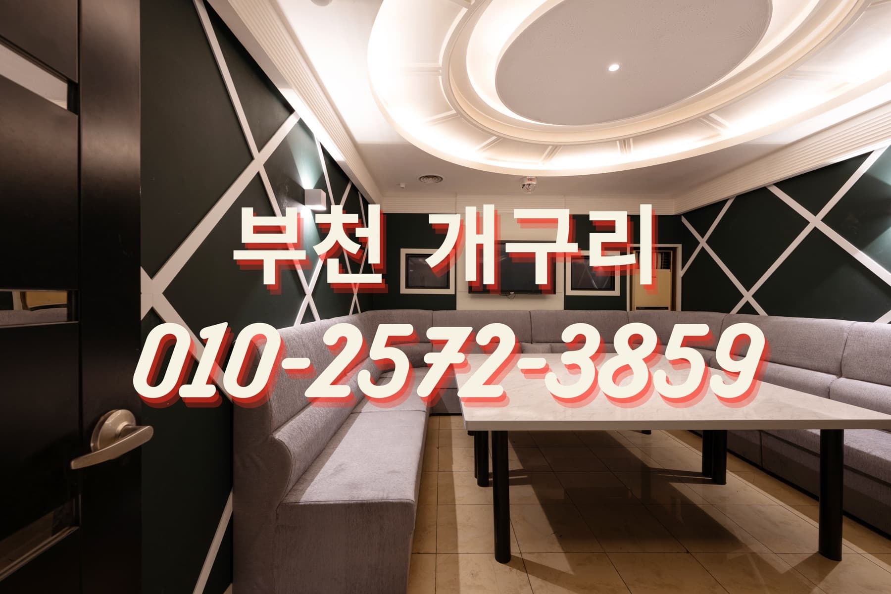 개구리 노래방 단체룸 입구에서 본 ㄷ자형 소파와 테이블